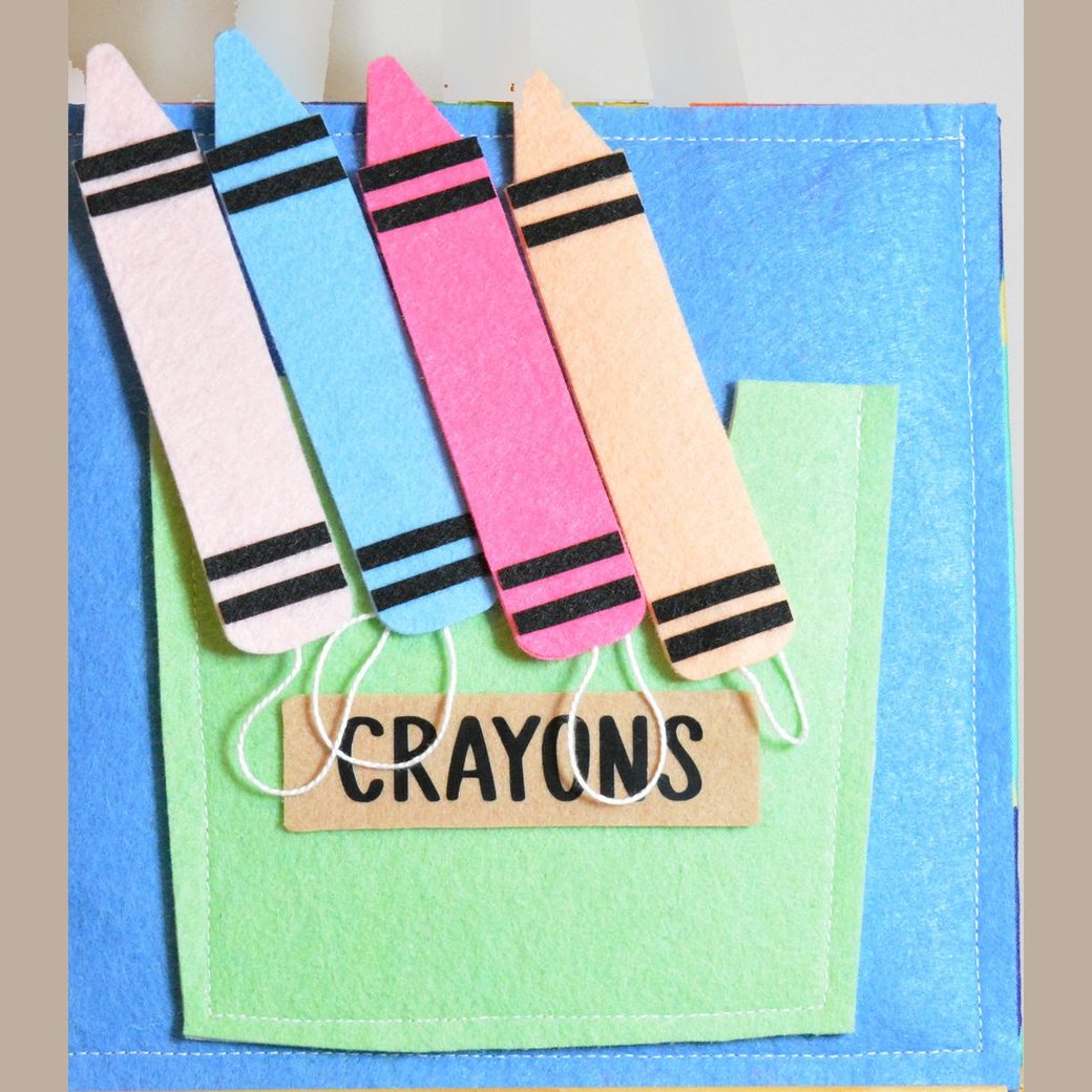 Felt busy book page: a box of coloured felt crayons that pull out and slot back into their places, on strings
